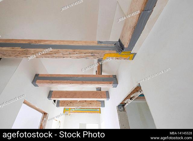 construction site, refurbishment and renovation of an apartment, masked wooden beam ceiling