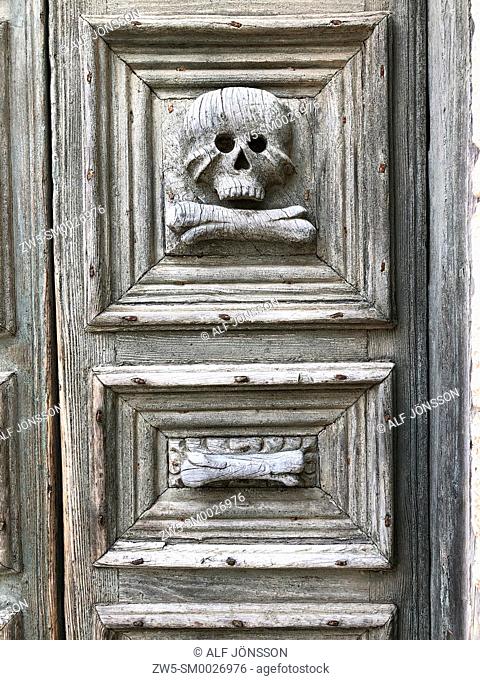 Skull and bone carved on the door of the Church of Purgatory, Matera, Basilicata. Italy