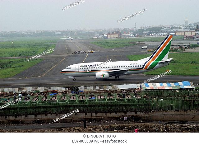 Commercial plane on runway ready for take off at Sahar airport or Chhatrapati Shivaji International airport in Bombay Mumbai ; Maharashtra ; India