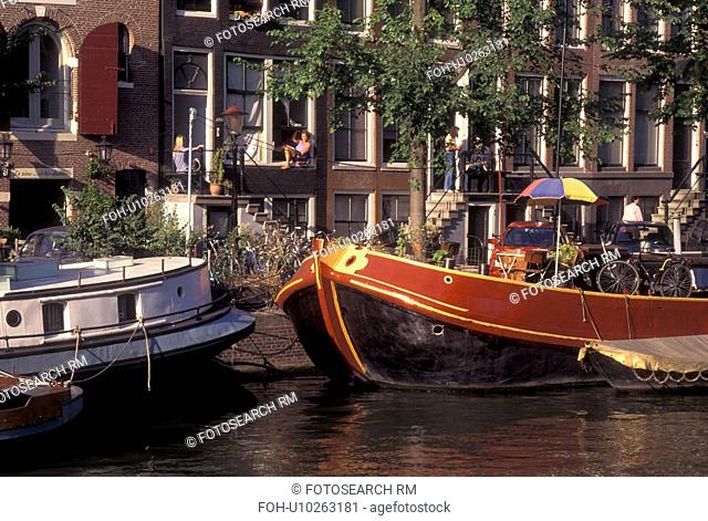 Amsterdam, Netherlands, Holland, Noord-Holland, Europe, Houseboats docked along a canal in Amsterdam