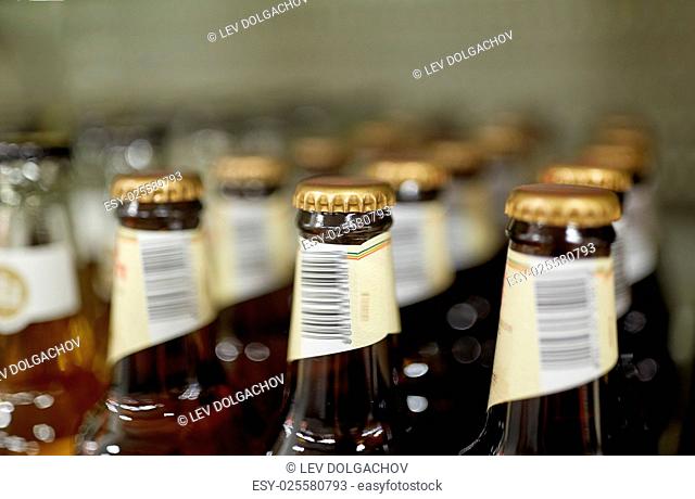 sale and alcohol concept - close up of bottles at liquor store