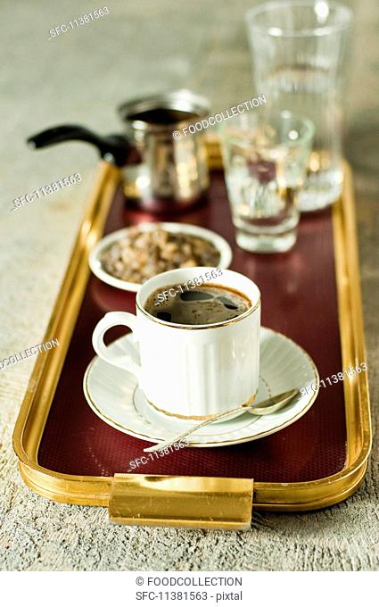 Turkish coffee and dark rock sugar on a tray