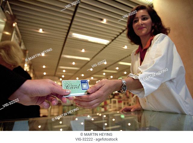 Symbolic picture: shoping with a storecard. Storecard of the Galeria Kaufhof, shop assistant. - BONN, GERMANY, 20/05/2003