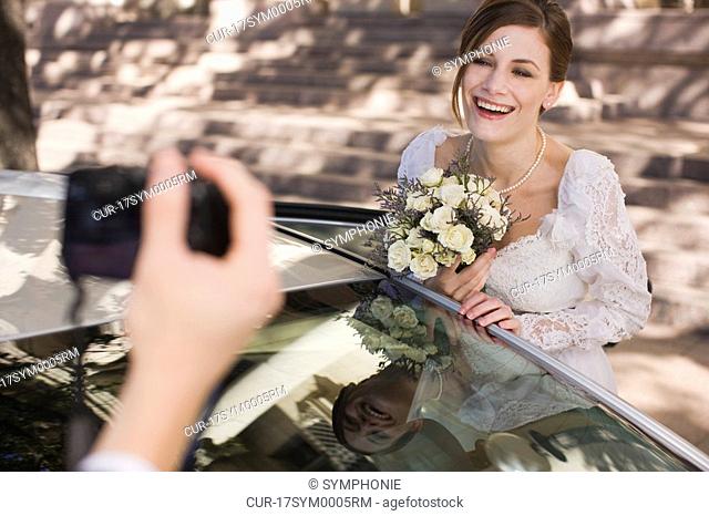 groom taking picture of bride