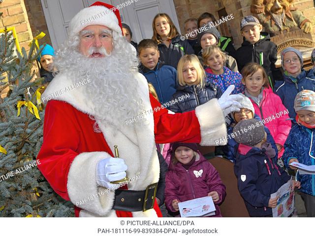 14 November 2018, Brandenburg, Himmelpfort: Santa Claus is greeted by children in front of the Christmas post office. On the same day Santa Claus arrived in...