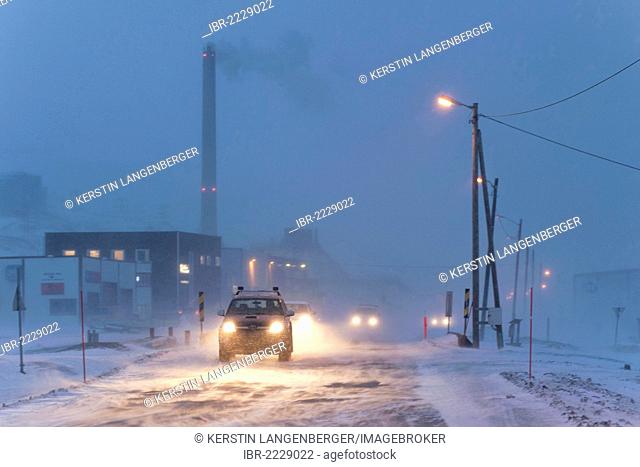 A winter's evening in the Arctic region, traffic during a blizzard, coal-fired power plant in Longyearbyen at back, Spitsbergen, Svalbard, Norway, Europe
