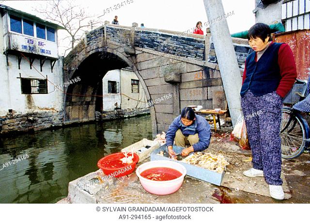 Killing chickens in a popular market by a canal. Suzhou. Kiangsu province, China