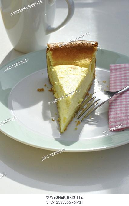 A slice of cheesecake on a plate with a fork