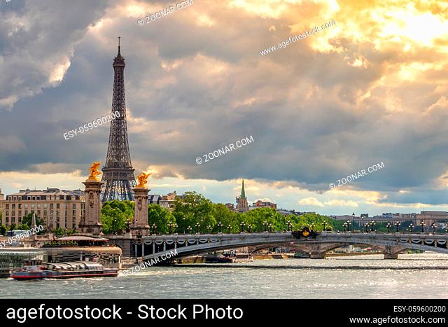 France. Paris. Heavy clouds and the rays of the sun. Traffic on the Seine