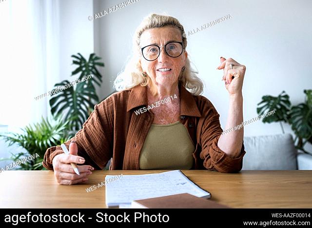 Smiling freelancer with vitiligo skin at desk in home office