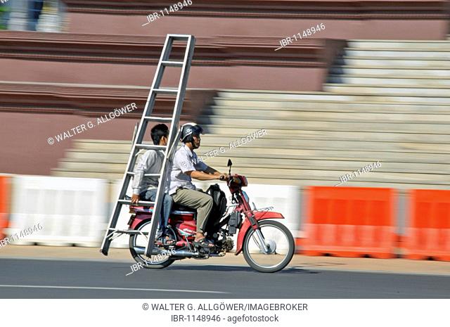 Ladder being transported on a moped, Phnom Penh, Cambodia, Asia