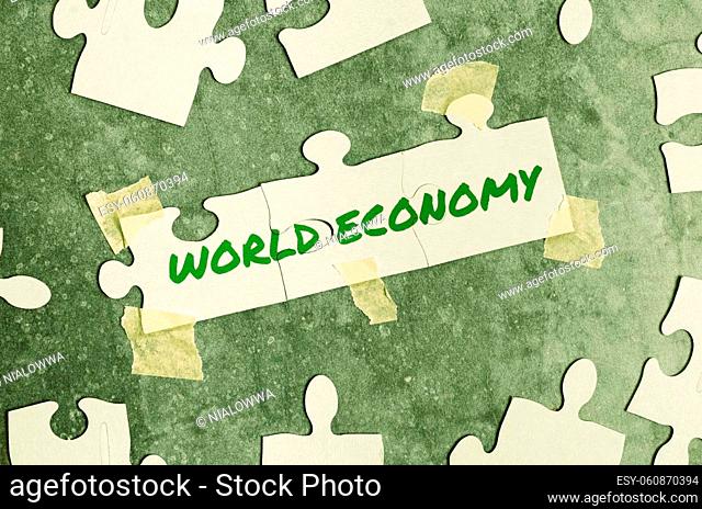 Text sign showing World Economy, Business idea Global Worldwide International markets trade money exchange Building An Unfinished White Jigsaw Pattern Puzzle...