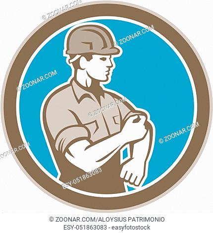 Illustration of a construction worker wearing hardhat rolling up sleeve facing side set inside circle on isolated background done in retro style