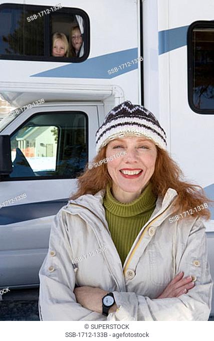 Portrait of a mature woman and her two daughters in a recreational vehicle
