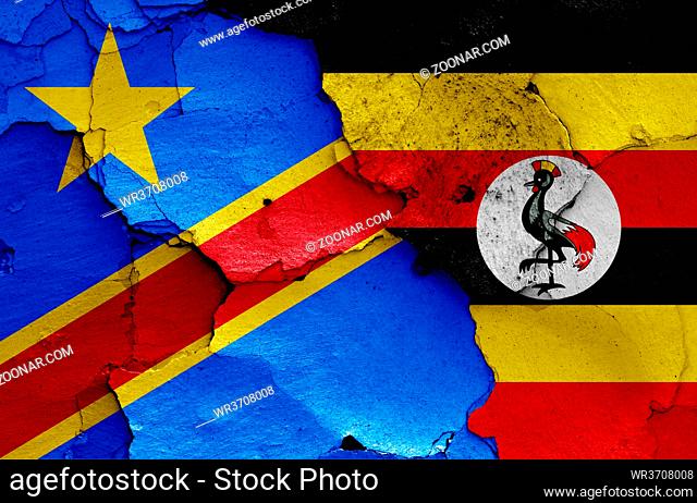 flags of DR Congo and Uganda painted on cracked wall