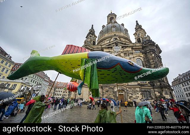20 August 2022, Saxony, Dresden: The theater group V.O.S.A. from Prague parades through Dresden's city center with its colorful figures and various equipment...