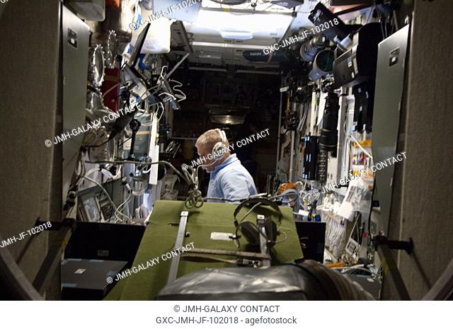 Russian cosmonaut Oleg Novitskiy, Expedition 34 flight engineer, monitors data at the manual TORU docking system controls in the Zvezda Service Module of the...