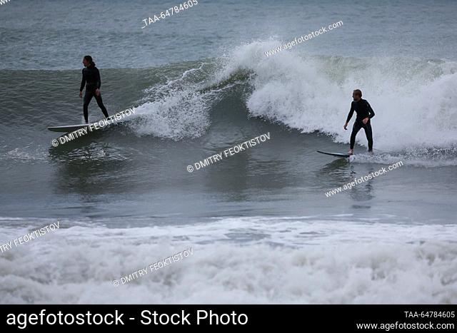 RUSSIA, SOCHI - NOVEMBER 13, 2023: Surfers ride waves during a storm on the Black Sea, in the Khosta neighbourhood. Dmitry Feoktistov/TASS