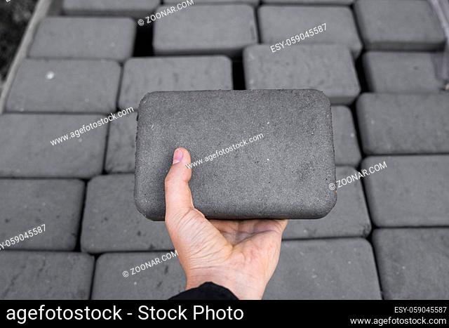 Stack of paving stone on construction site. Bricks for paving stones stacked in stacks, background texture structure. Gray pavement bricks for pavement road