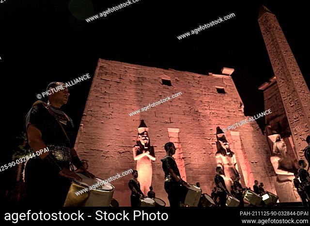 25 November 2021, Egypt, Luxor: Men in pharaohs costumes play the drums during the grand reopening ceremony of the Avenue of Sphinxes