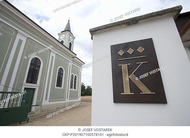 Church in Kladruby nad Labem and logo of the Kladruby stud, Czech Republic, July 10, 2019. The Kladruby nad Labem national stud