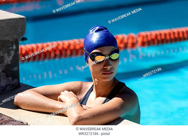 Female swimmer standing in swimming pool