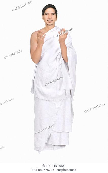 Handsome asian muslim with ihram cloth isolated over white background