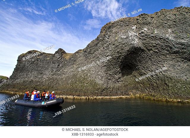 Zodiac cruising among columnar basalt in Hvalvík Bay on the northern coast of Iceland  MORE INFO Hvalvík Bay exhibits classic columnar basalt formations and is...