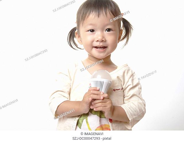 Girl holding a LED bulb