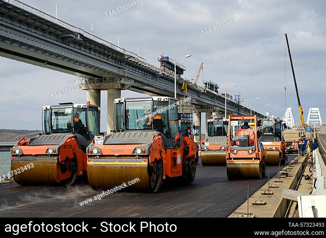 RUSSIA, REPUBLIC OF CRIMEA - FEBRUARY 12, 2023: Paving asphalt on the left side of the motor section of the bridge linking Crimea to mainland Russia; 260 meters...