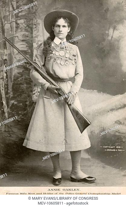 Annie Oakley - famous rifle shot and holder of the Police Gazette championship medal. Portrait photograph of sharpshooter Annie Oakley, full-length portrait