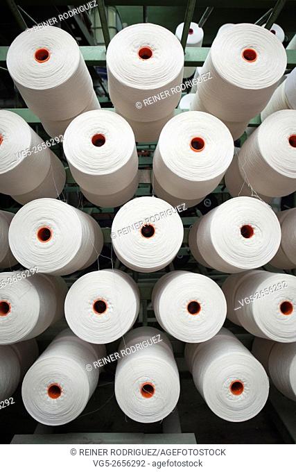 production of fine woolen fabrics for suits - in a factory in Sabadell, Spain. rolls of woolen threads
