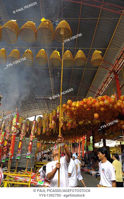 Devotees hang incense swirls and ceremonial lanterns high among the rafters , Vegetarian festival at San Jao Sieng Kong shrine , wat sung heng yee, Chinatown