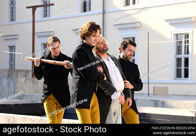 28 July 2021, Brandenburg, Rheinsberg: Singers costumed as guards and singer Brad Cooper (l) as Florestan perform ""Fidelio oder die eheliche Liebe"" (Ludwig...