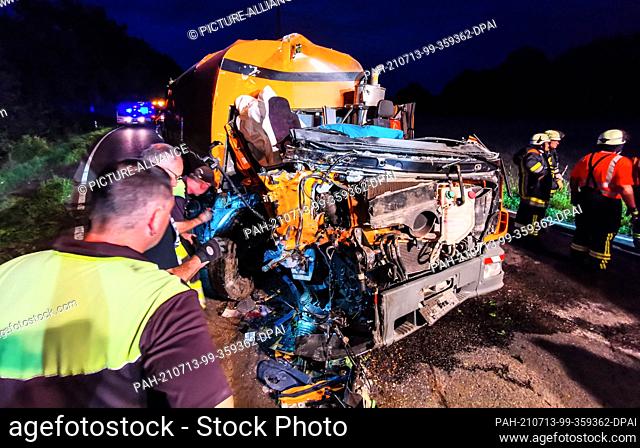 12 July 2021, Baden-Wuerttemberg, Waibstadt: Rescue workers stand at the scene of an accident involving a street cleaning machine