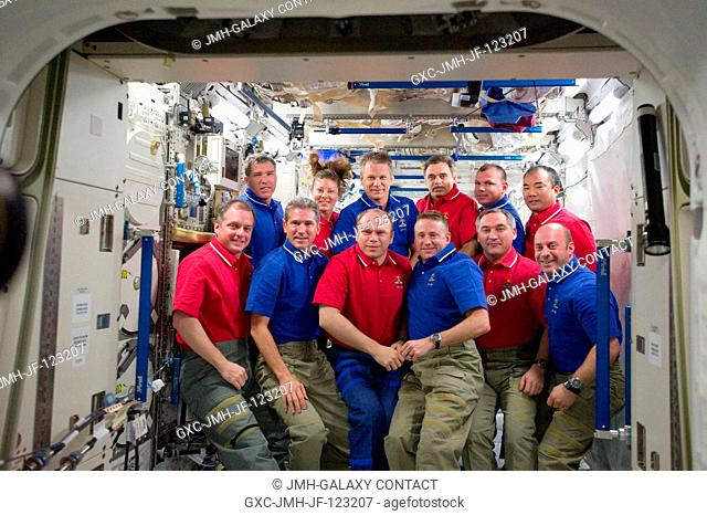 STS-132 (blue shirts) and Expedition 23 crew members pose for a group portrait on the International Space Station while space shuttle Atlantis remains docked...