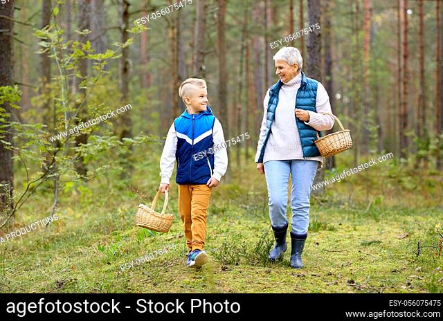 grandmother and grandson with mushrooms in forest