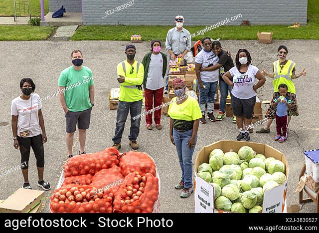 Detroit, Michigan - Volunteers in the Morningside neighborhood pose for a photo while distributing free food in a low-income part of the city