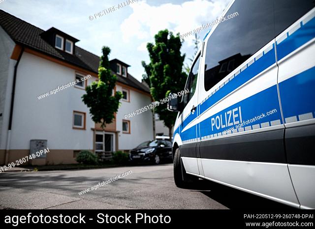 12 May 2022, North Rhine-Westphalia, Essen: A police car is parked in front of the suspect's home in Essen. Police in Essen are investigating a 16-year-old for...