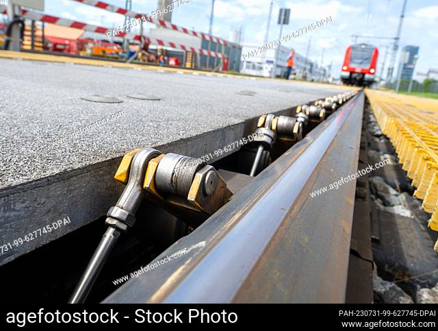 31 July 2023, Bavaria, Munich: An S-Bahn train stands in front of a digitized wheel scanning system at the Munich-Steinhausen S-Bahn plant during a press and...