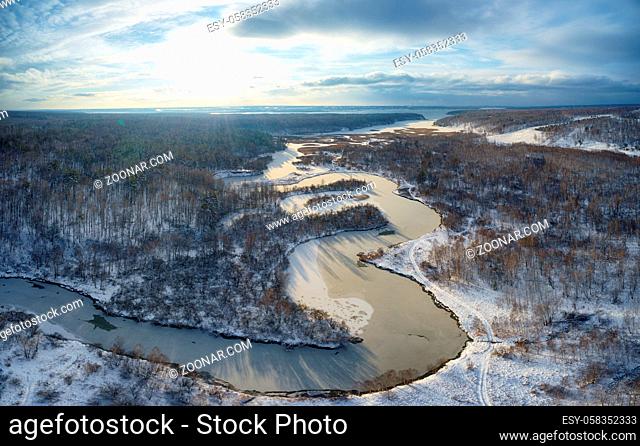 Aerial photo panorama of Koen river under ice and snow. Beautiful winter landscape. Novosibirsk, Siberia, Russia