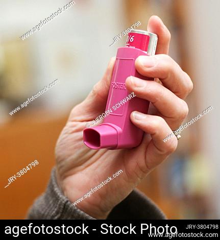 Germany, Bornheim, 12.04.2021: A woman picks up an asthma spray. A study shows that asthma sprays can alleviate the course of Covid-19 disease