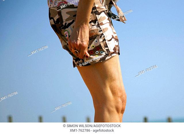 Young woman wearing shorts on the beach