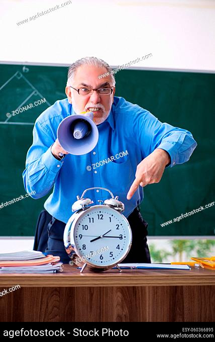 Senior male math teacher in time management concept
