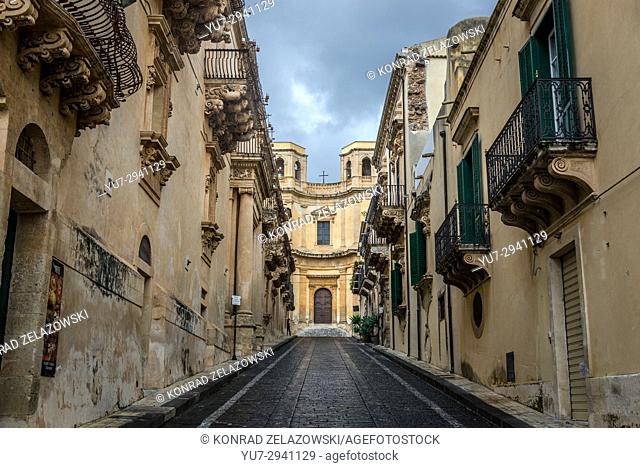 View of narrow street and Church of Montevergine (Chiesa di Montevergine) in Noto town, Province of Syracuse on Sicily Island in Italy