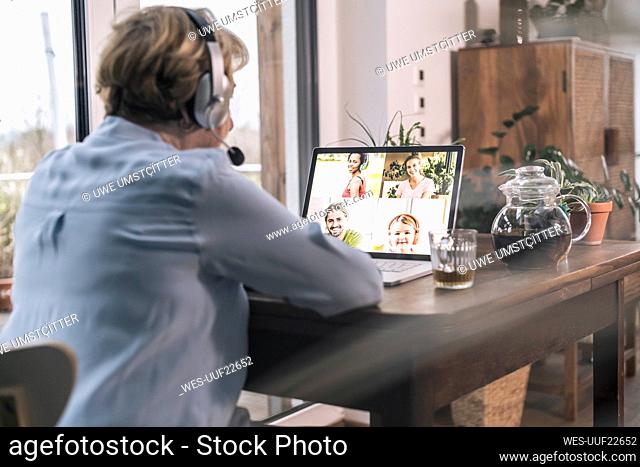 Family on video call through laptop at home
