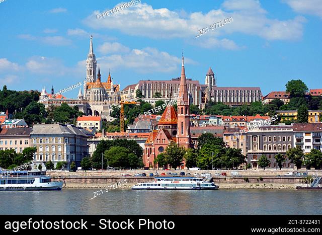 View across the river Danube to the historic buildings in Buda with Matyas church, Fishermen's Bastion and Calvin's church in Budapest - Hungary