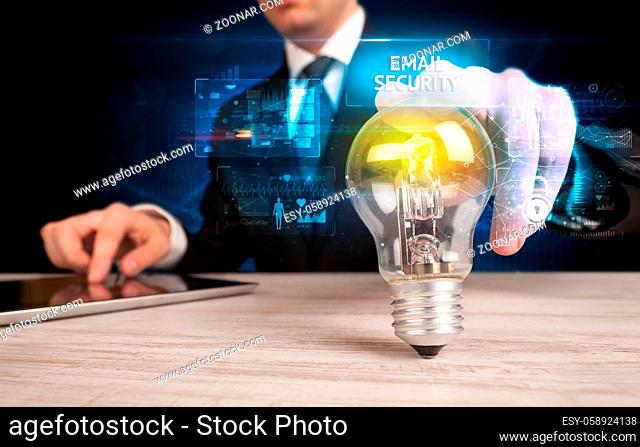 Businessman holding lightbulb with EMAIL SECURITY inscription, online security idea concept