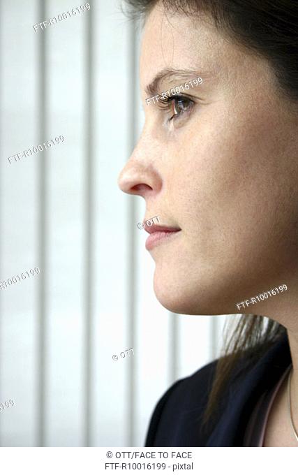 Side view of a woman seen as she is pleased by looking at something