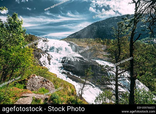 Kinsarvik, Hordaland, Norway. Waterfall Nyastolfossen In Hardangervidda Mountain Plateau. Nyastolsfossen in Spring Sunny Day. Height Of 115 m